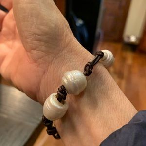 Pearl bracelet on leather strands.